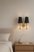 Bedroom with a nightstand, lamp, and decorative items.