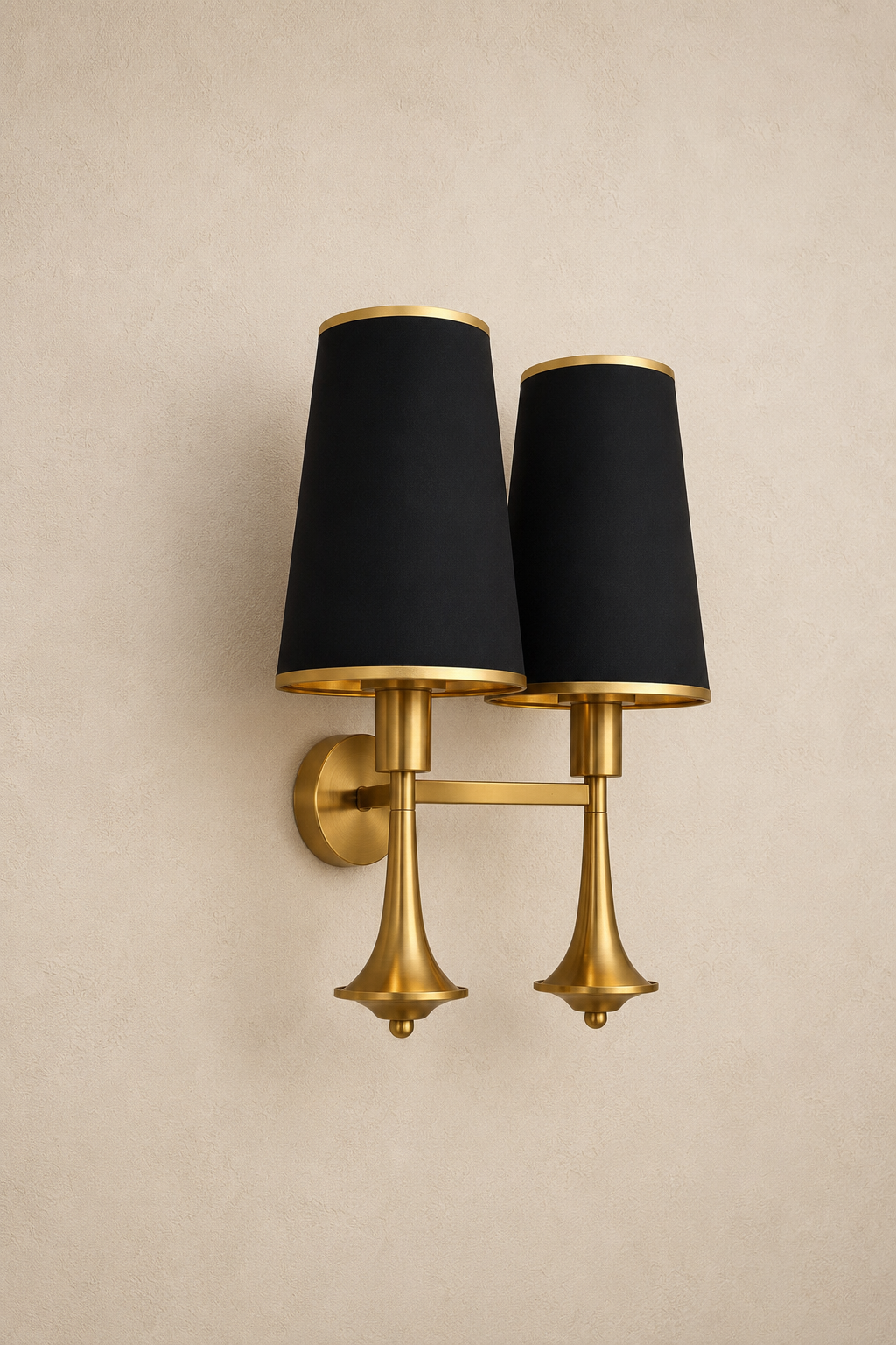 Wall-mounted lamp with black lampshades and gold fixture on a beige wall.