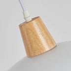 Wooden lampshade with white cord on a light gray background