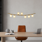 Modern office setup with a desk, chair, and hanging lamp.