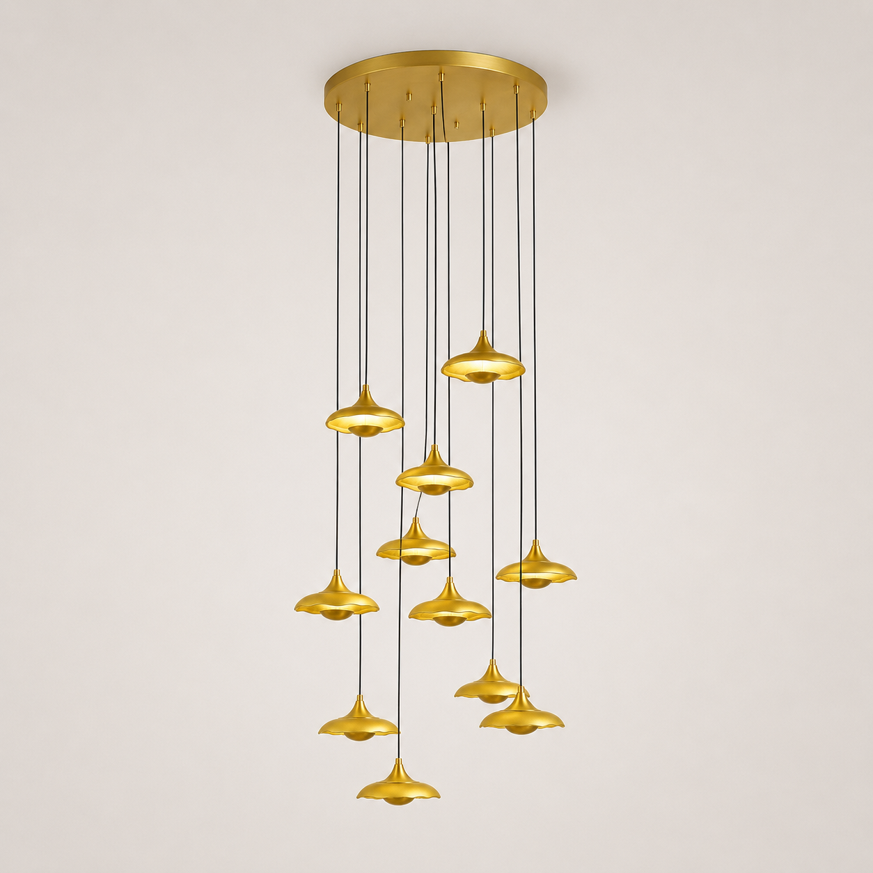 Gold pendant light fixture on a plain background