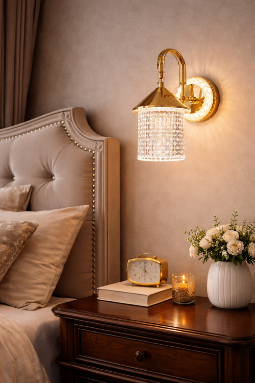 Decorative wall sconce above a nightstand with books, clock, and flowers.
