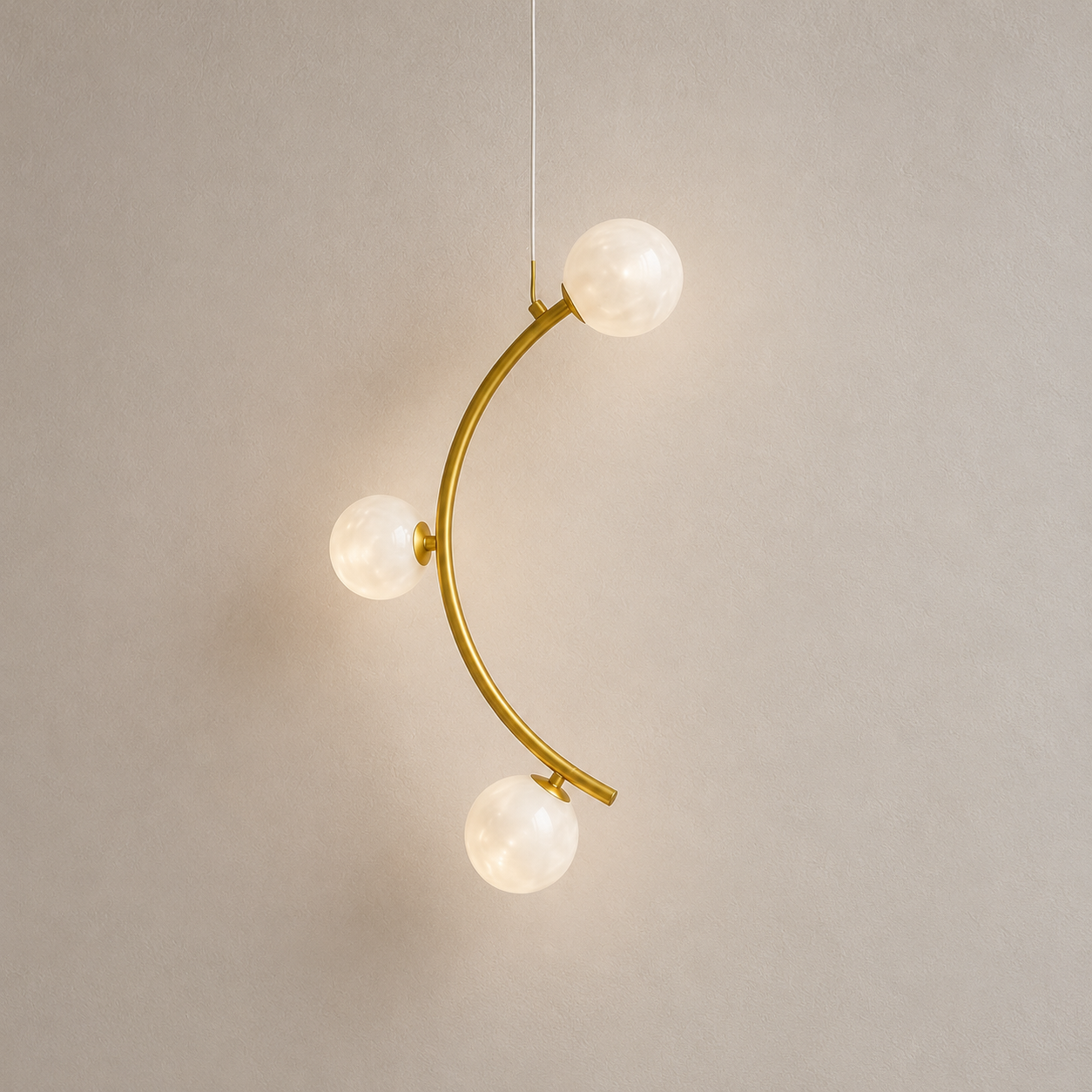 Modern gold pendant light with three spherical bulbs on a neutral background