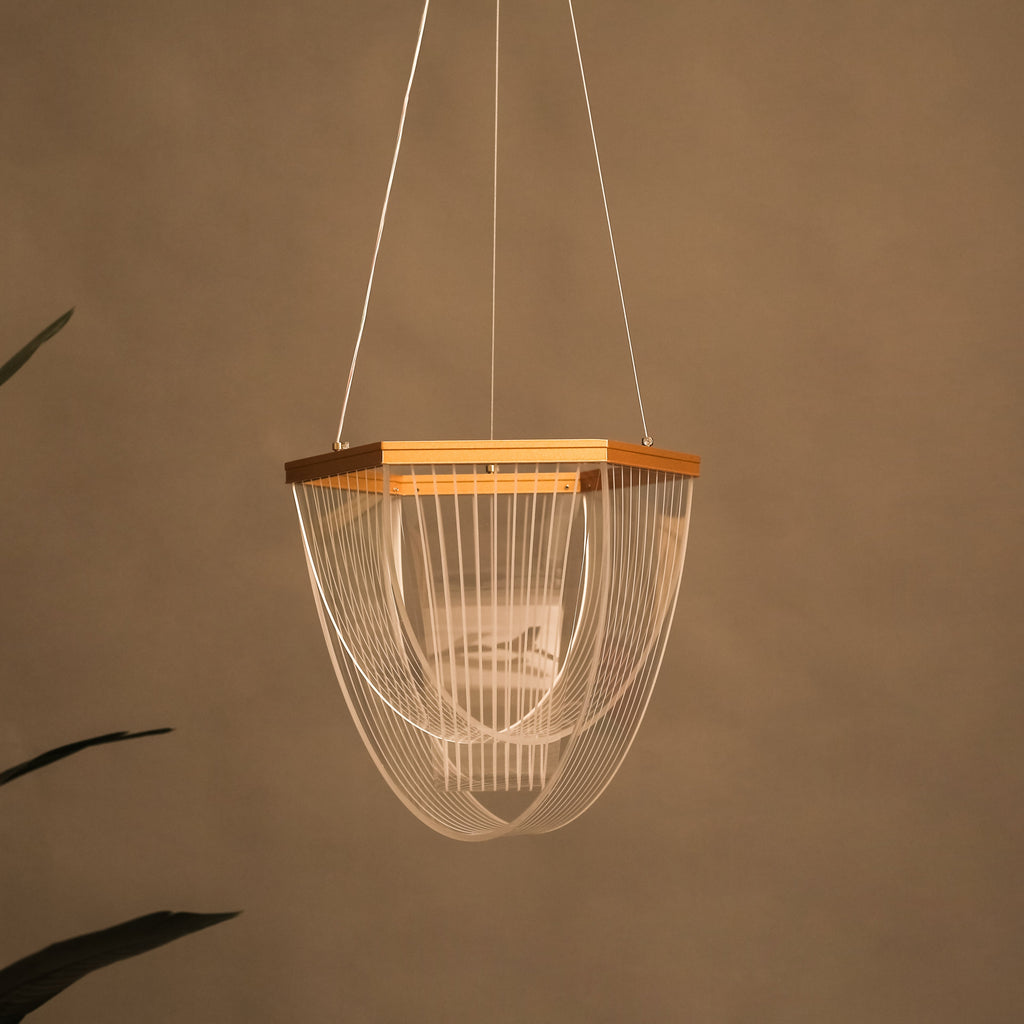 Modern pendant light with wooden accent against a brown wall