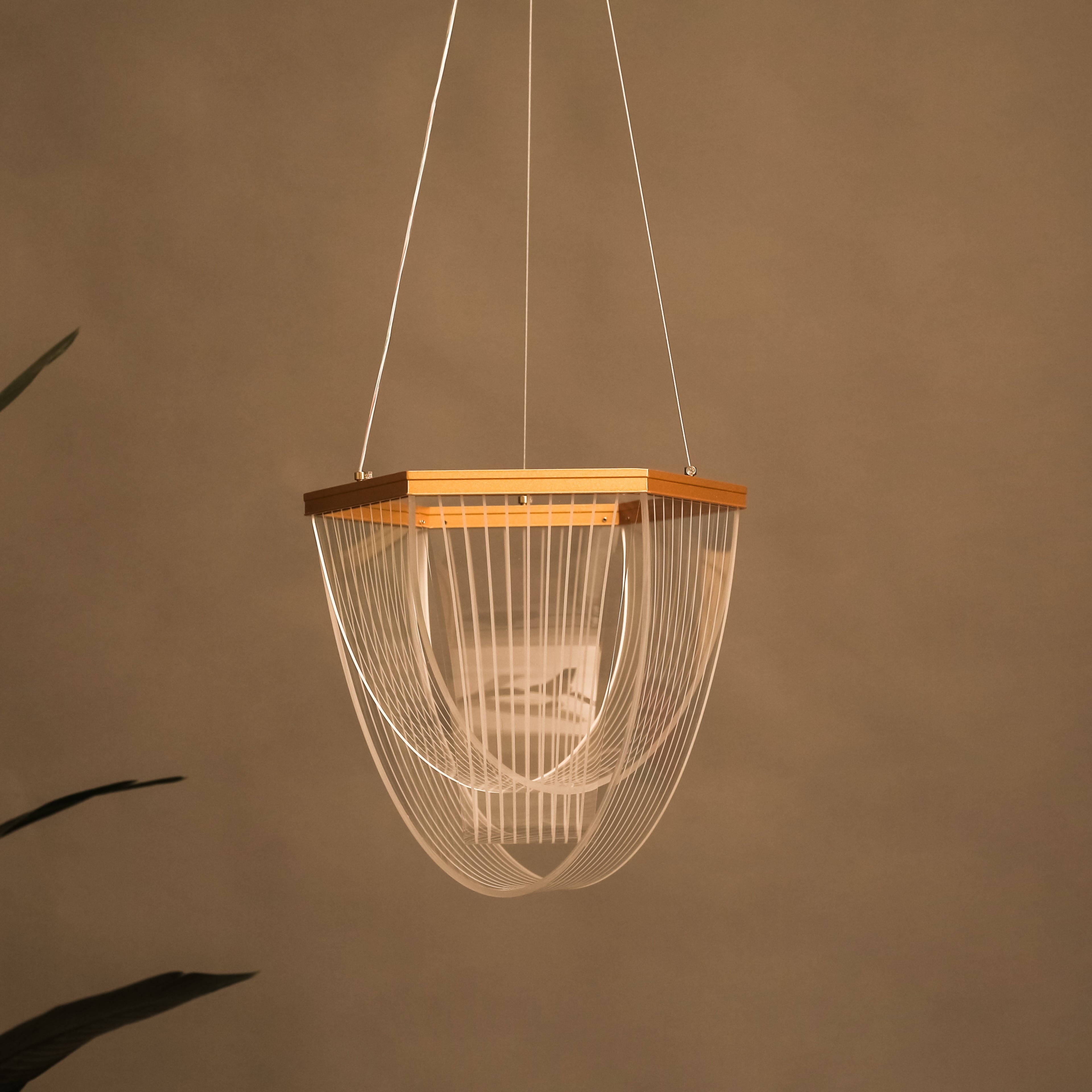 Modern pendant light with wooden accent against a brown wall