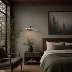 Cozy bedroom with wooden furniture, pendant light, and forest-themed decor.