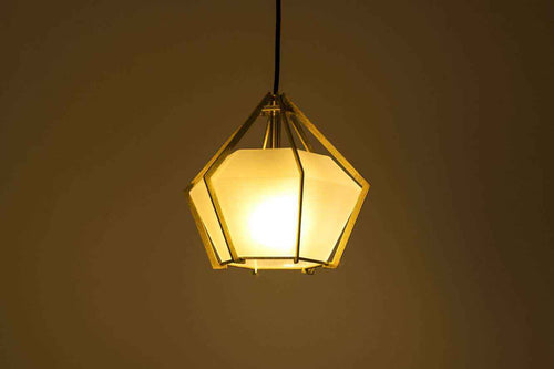 Geometric pendant light with a warm glow on a dark background
