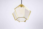 Geometric pendant light with white shade and gold frame on a light gray background