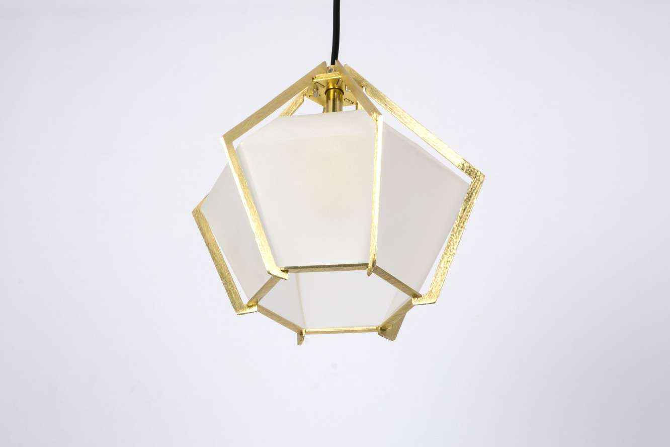 Geometric pendant light with white shade and gold frame on a light gray background
