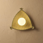 Triangular wall light fixture on a beige wall