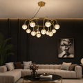 Modern living room with a chandelier, sofa, and wall art.