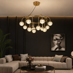 Modern living room with a chandelier, sofa, and wall art.