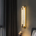 Decorative wall light fixture on a dark wall with a curtain in the background