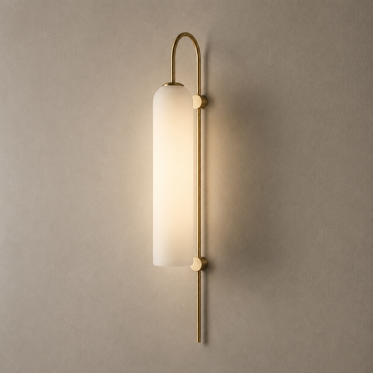 Wall-mounted light fixture with gold finish and white glass shade on a beige wall.