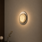 Round wall light fixture on a beige wall with soft glow
