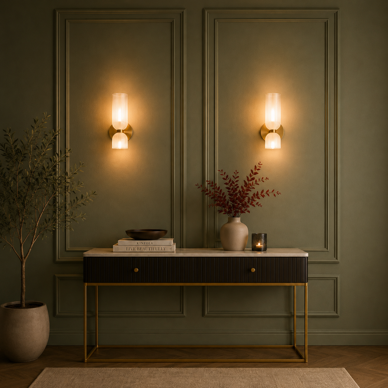Decorative interior setting with wall lights, a console table, and plants.