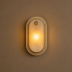 Wall-mounted light fixture with textured design on a beige wall