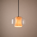 Pendant light with wooden shade and glass cover on a beige background