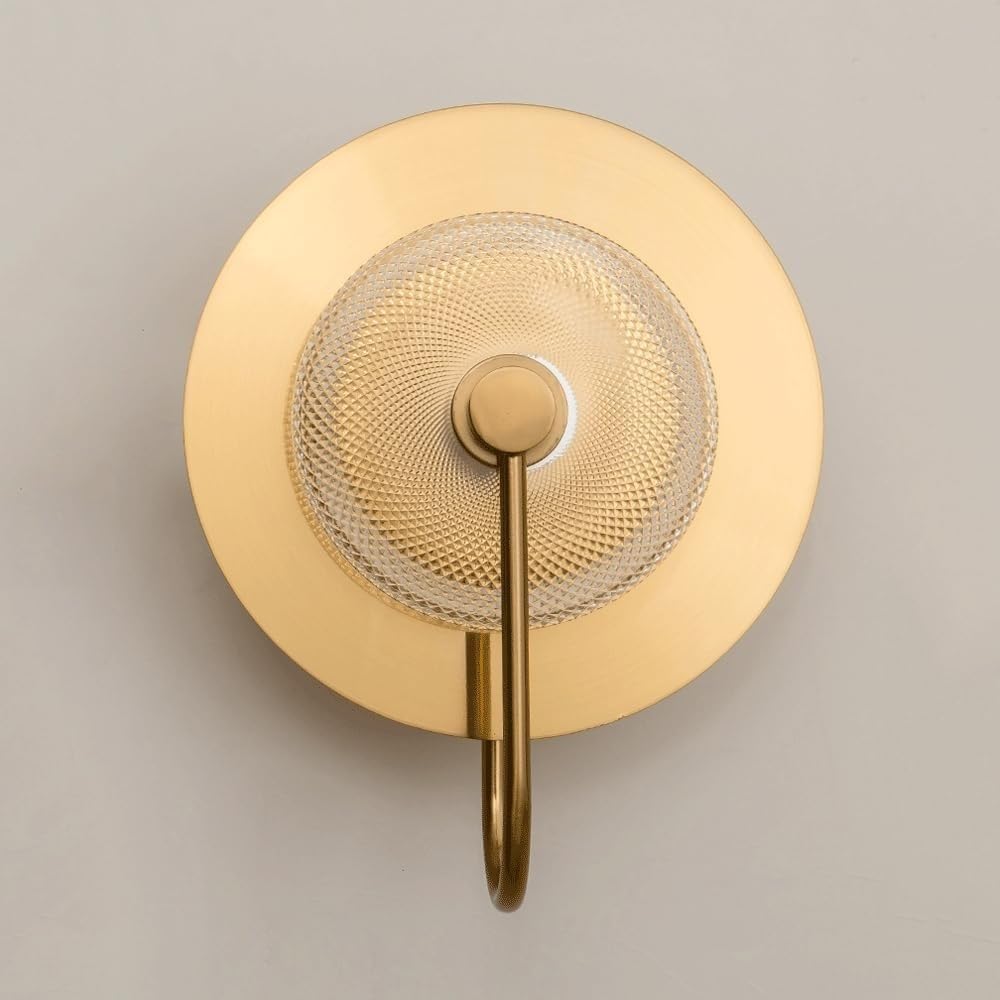 Gold wall-mounted shower head on a neutral background