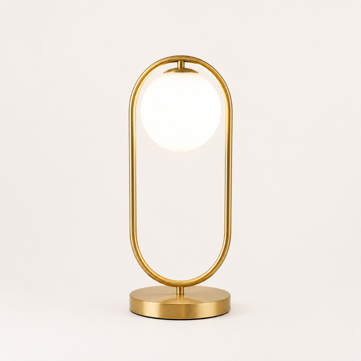 Gold table lamp with a white shade on a light beige background
