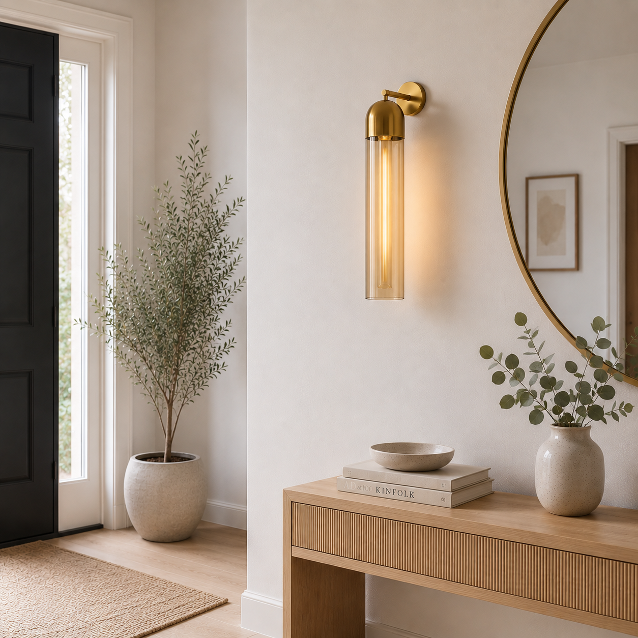 Modern interior design with a wall sconce, round mirror, and decorative items.