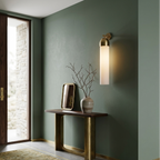 Modern interior design with a console table, wall lamp, and decorative elements.