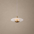 Pendant light with white glass shade and gold fixture on a beige background