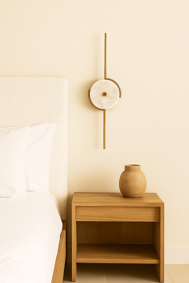 Wooden nightstand with a vase next to a bed in a bedroom setting