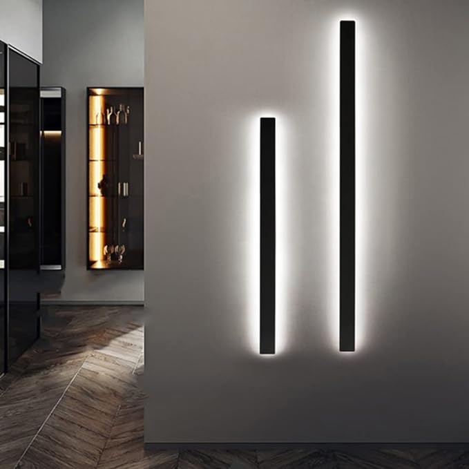 Modern wall lights on a gray wall with a room in the background