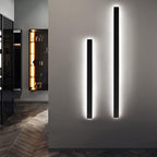 Modern wall lights on a gray wall with a room in the background
