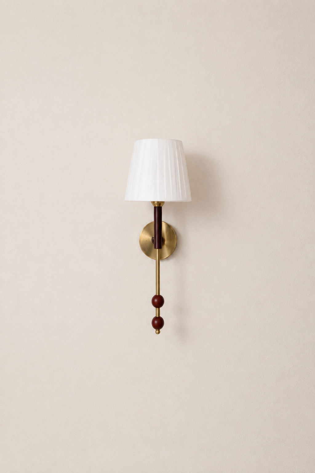 Wall-mounted lamp with a white shade and decorative elements on a beige wall