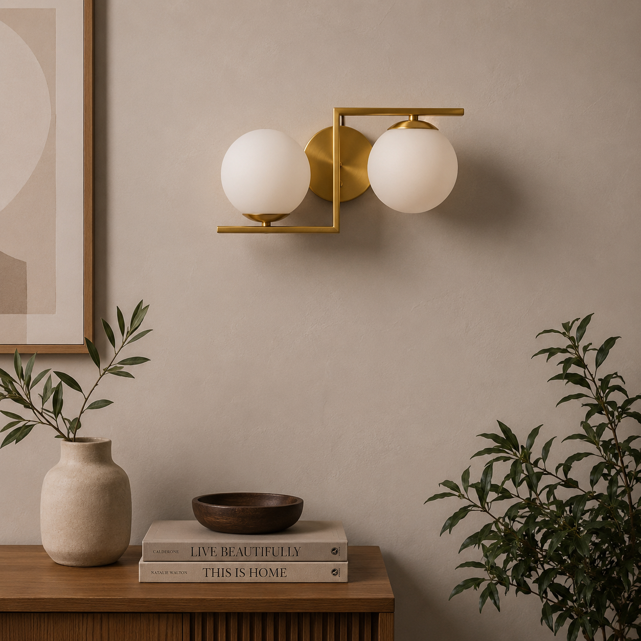 Modern wall sconce with two white glass globes on a neutral wall with decor items below.