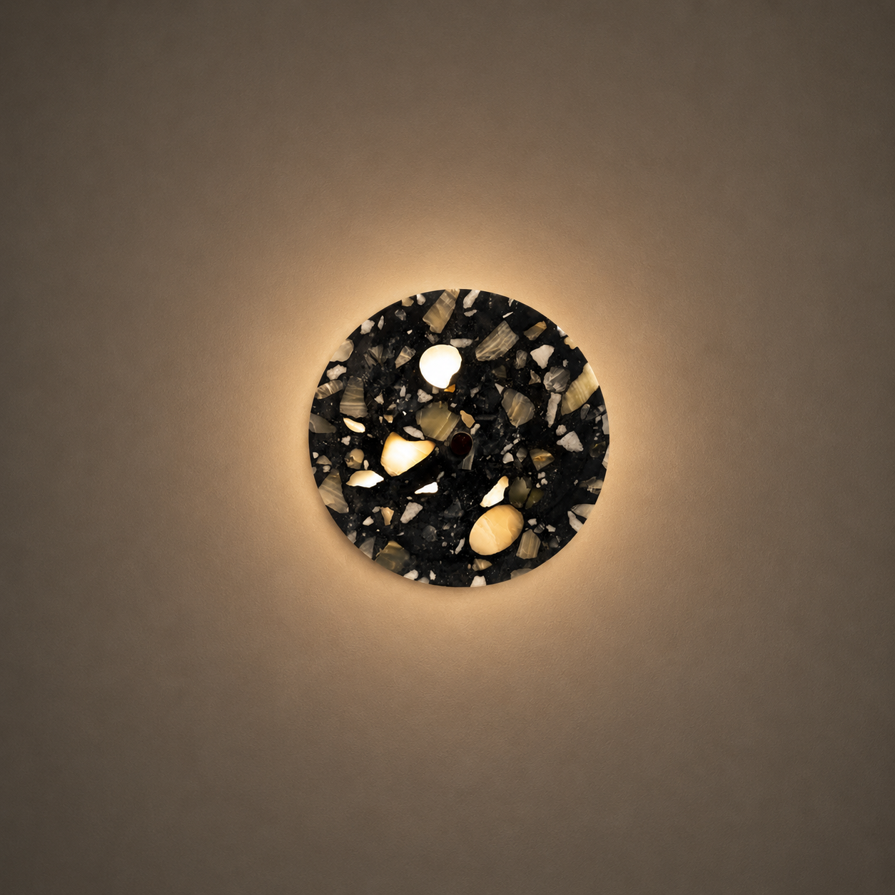 Round wall light fixture with a decorative black and white pattern on a beige wall.