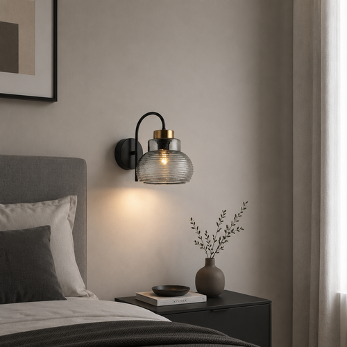 Modern wall sconce in a bedroom setting with a bed and side table.