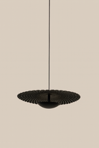 Black pendant light fixture on a beige background