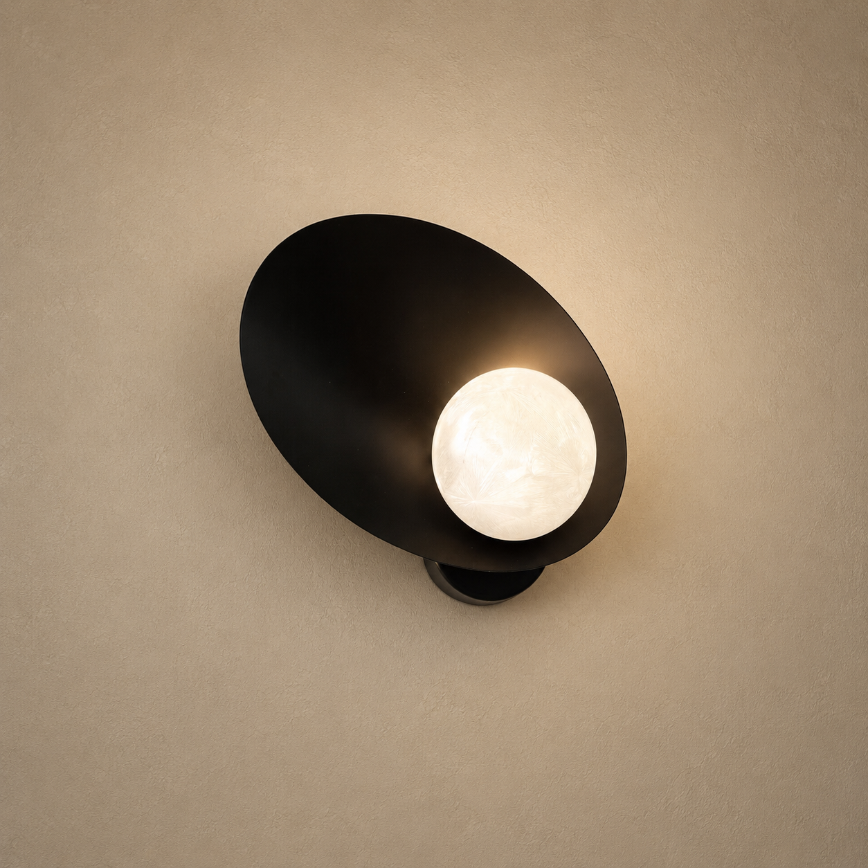 Black wall-mounted light fixture on a beige wall
