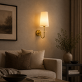 Cozy living room with a wall lamp, sofa, and decorative items.
