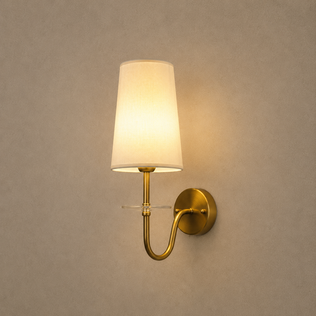 Wall-mounted lamp with a white shade and gold fixture on a beige wall.