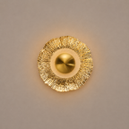 Gold wall sconce on a beige background