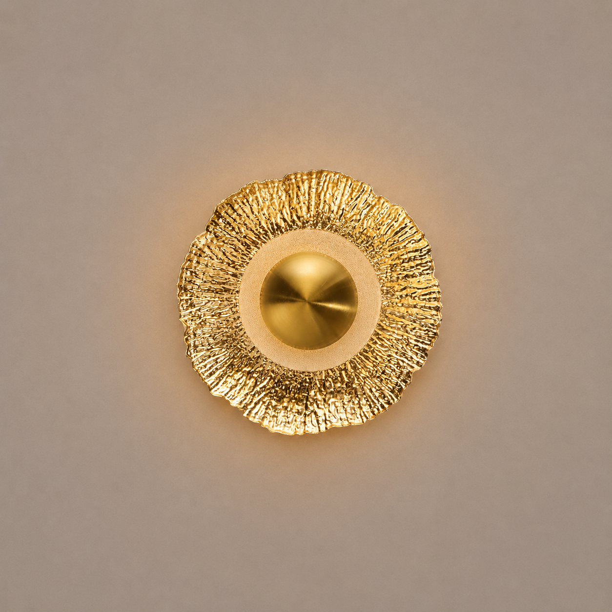 Gold wall sconce on a beige background