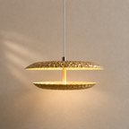 Gold pendant light fixture on a neutral background