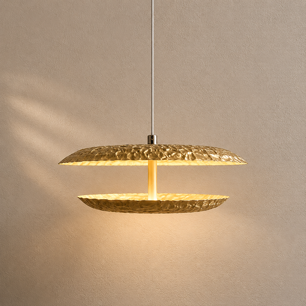 Gold pendant light fixture on a neutral background
