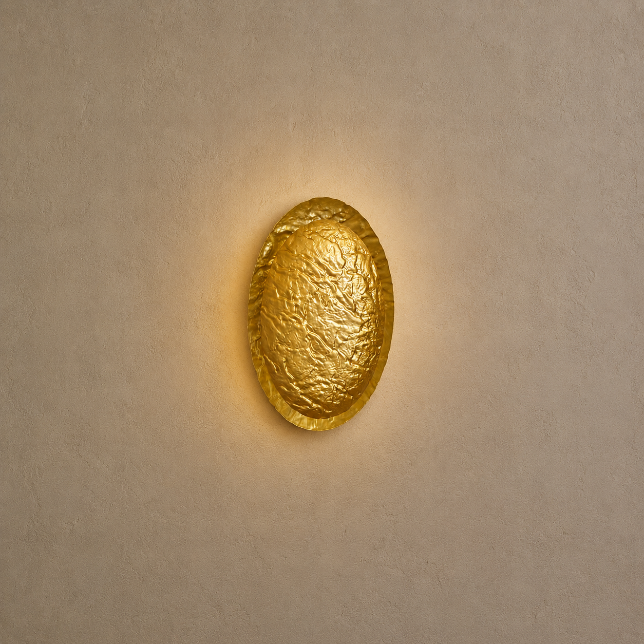 Gold wall sconce on a beige wall