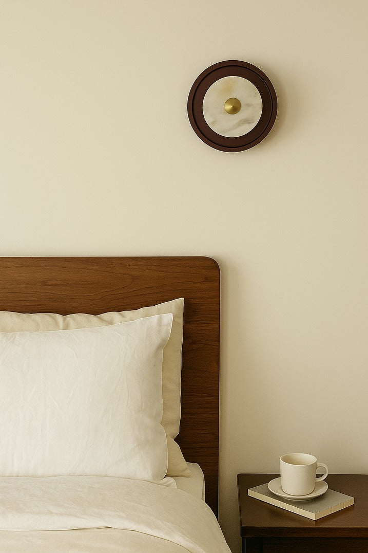 Bedroom with wooden headboard, white pillows, and a small table with a cup and saucer.