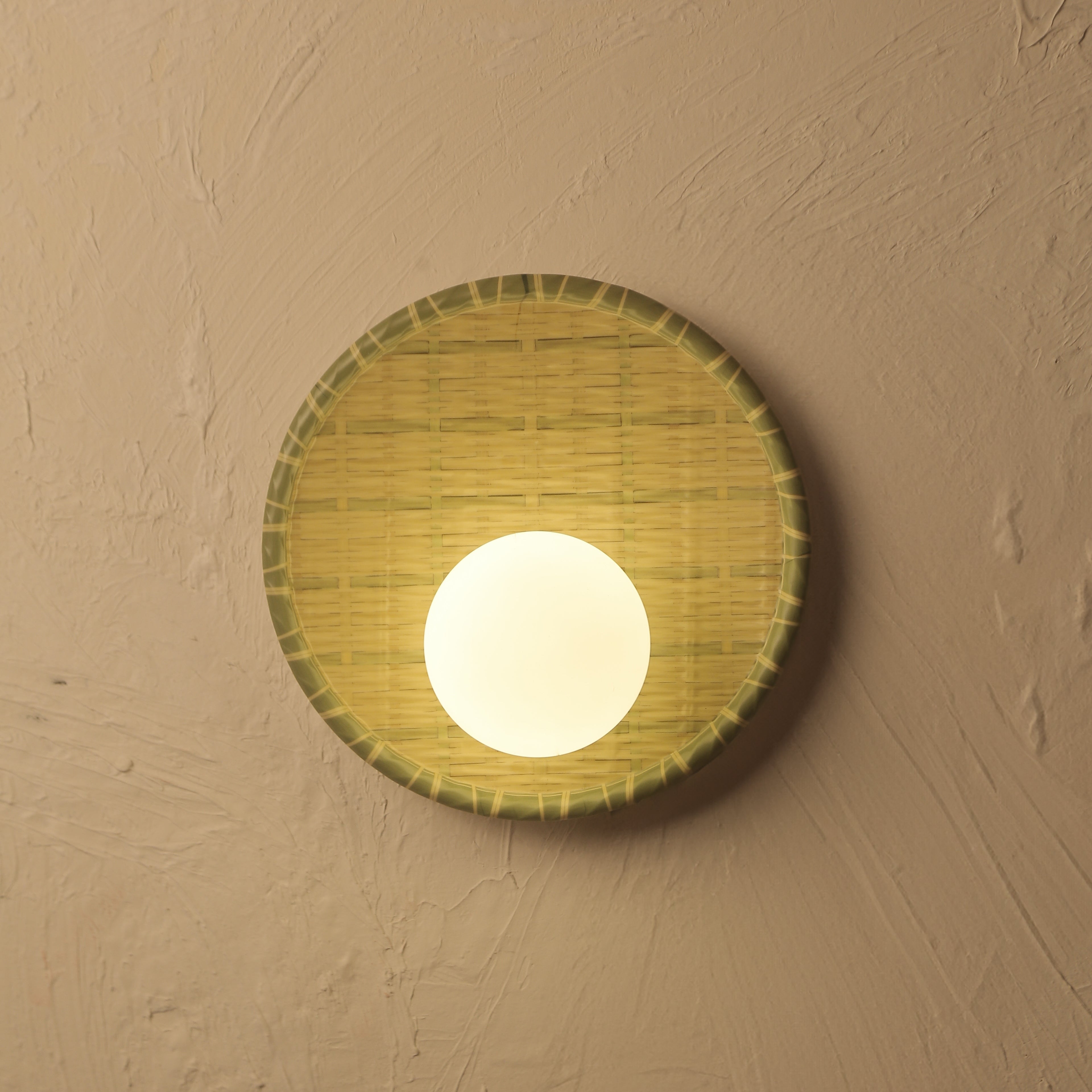 Round wall light fixture on a beige wall