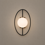 Wall-mounted light fixture with a round glass shade on a beige wall