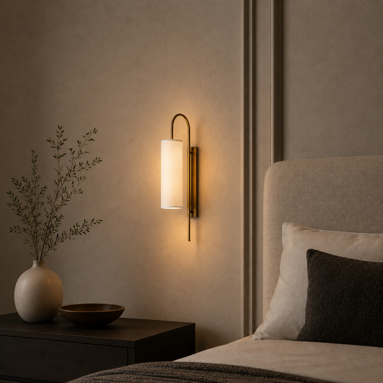 Modern wall sconce in a bedroom setting with a vase and plant on a nightstand.