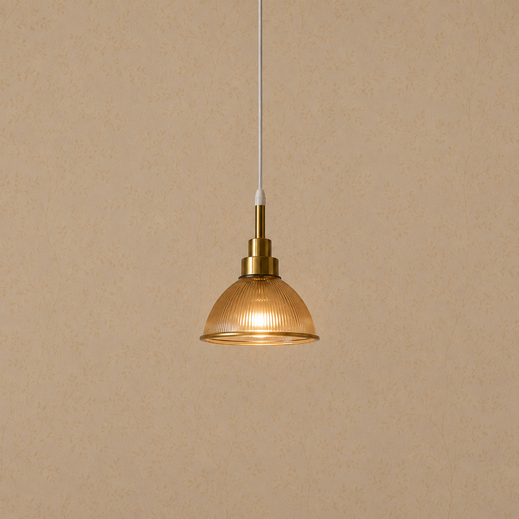 Gold pendant light with glass shade on a beige background
