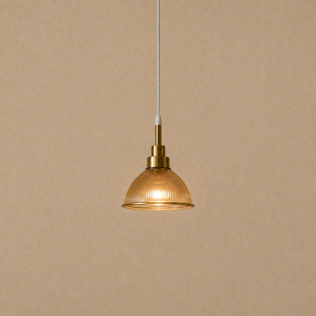 Gold pendant light with glass shade on a beige background