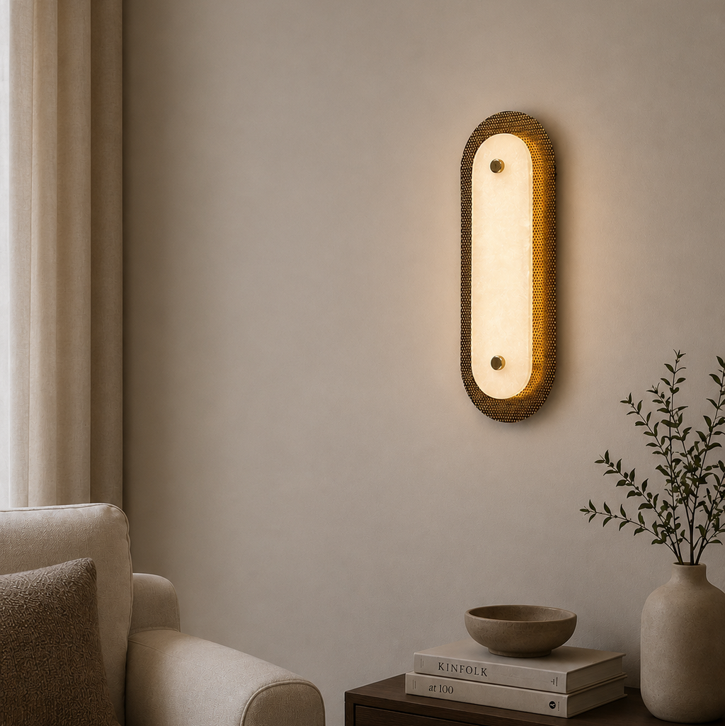 Wall-mounted light fixture in a living room setting with a sofa and decor items.
